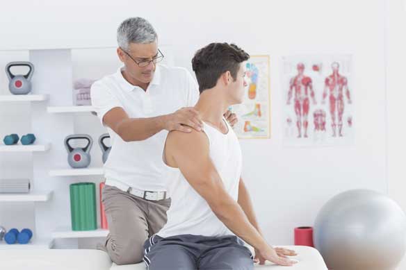 Muscular man getting a massage