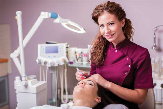 Woman at spa getting her eyebrow's plucked