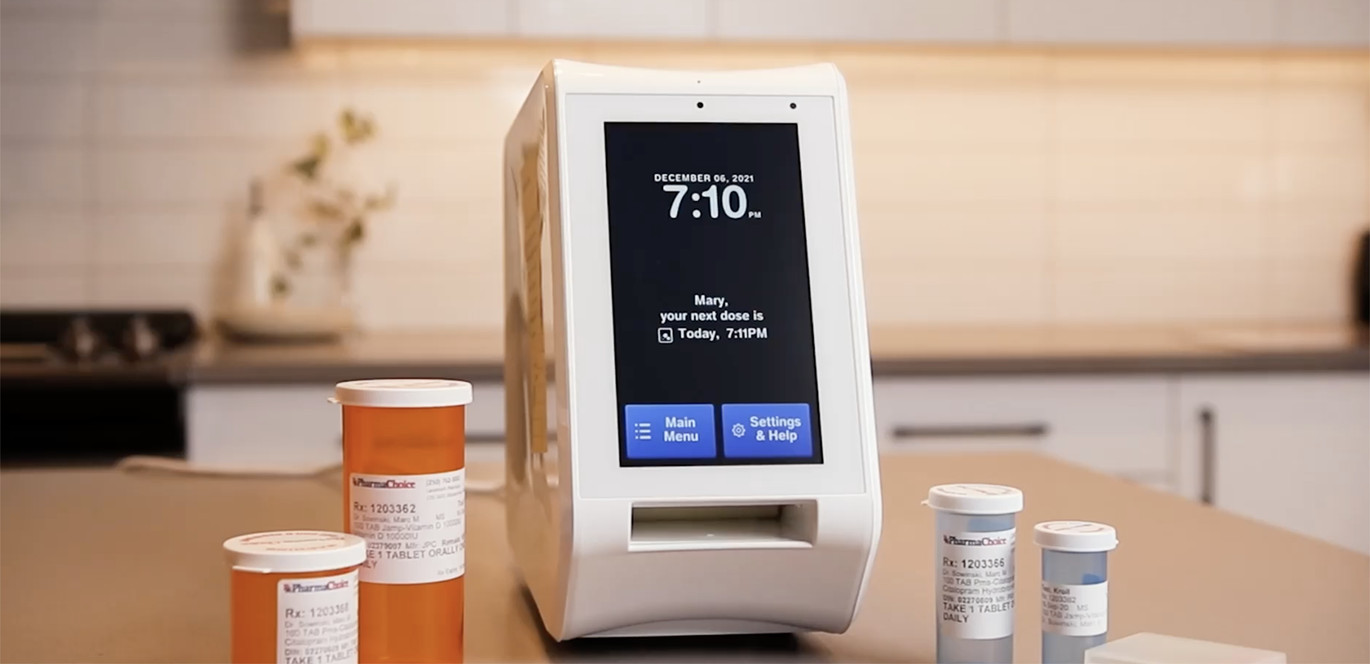 Spencer medication dispenser on countertop with prescription bottles